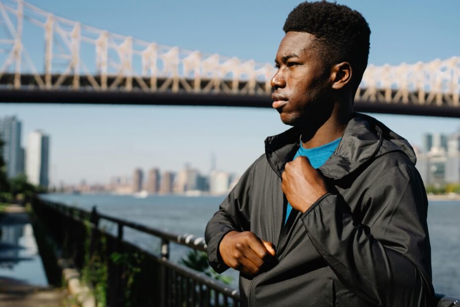 Stylish man wearing a durable and versatile men's travel jacket, perfect for urban city breaks and rugged outdoor adventures, featuring weather resistance and secure pockets.