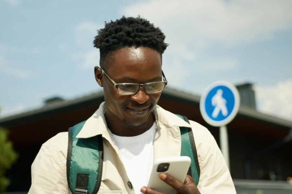 Black traveler confidently using the Martinique Lewis ABC Travel Green Book app on a smartphone to discover safe and welcoming destinations, supporting Black-owned businesses.