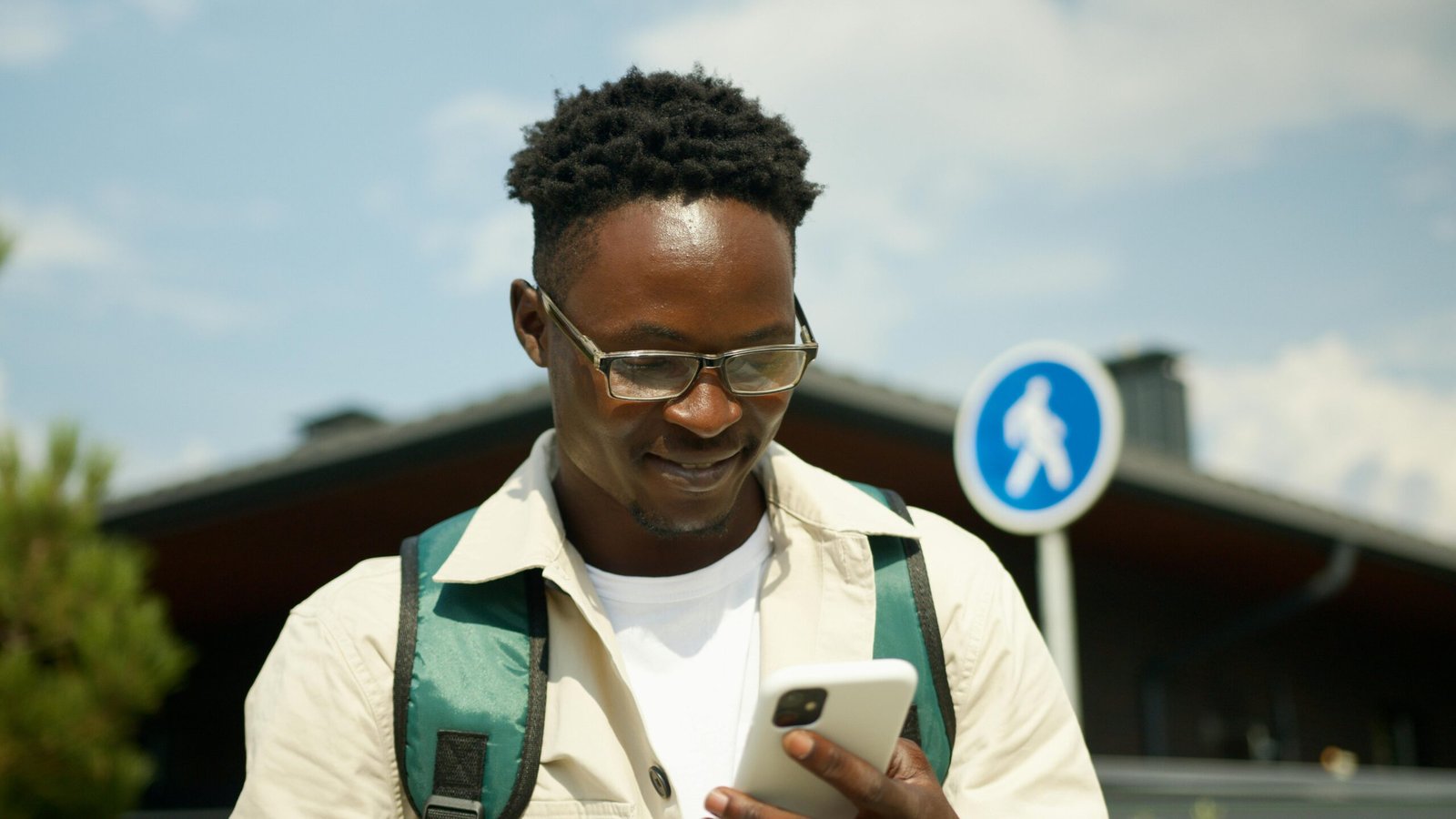 Black traveler confidently using the Martinique Lewis ABC Travel Green Book app on a smartphone to discover safe and welcoming destinations, supporting Black-owned businesses.