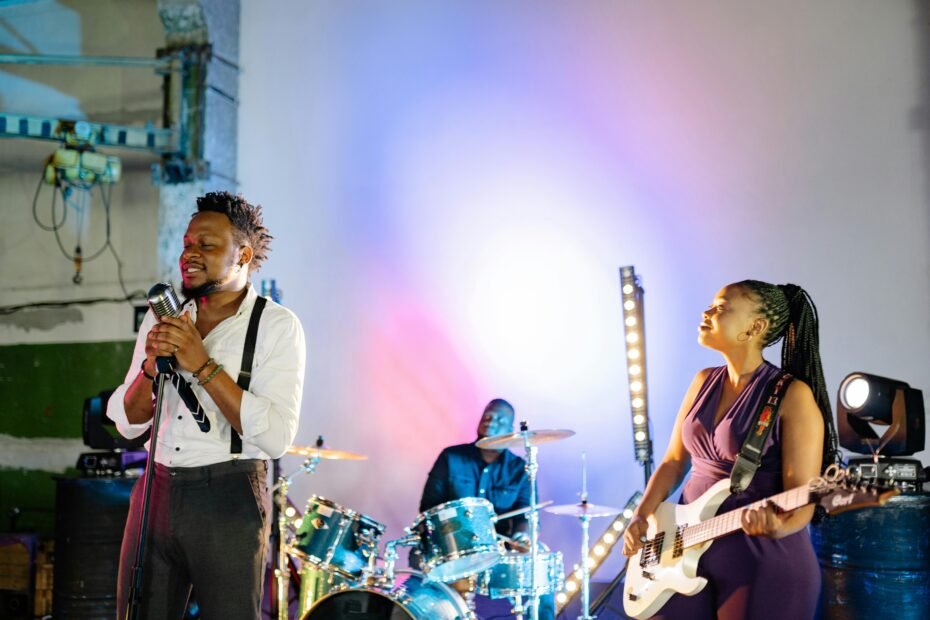 Energetic blues rock band live performance, featuring musicians playing harmonica, guitar, drums, bass, and keyboards, highlighting their iconic sound and vibrant stage chemistry.