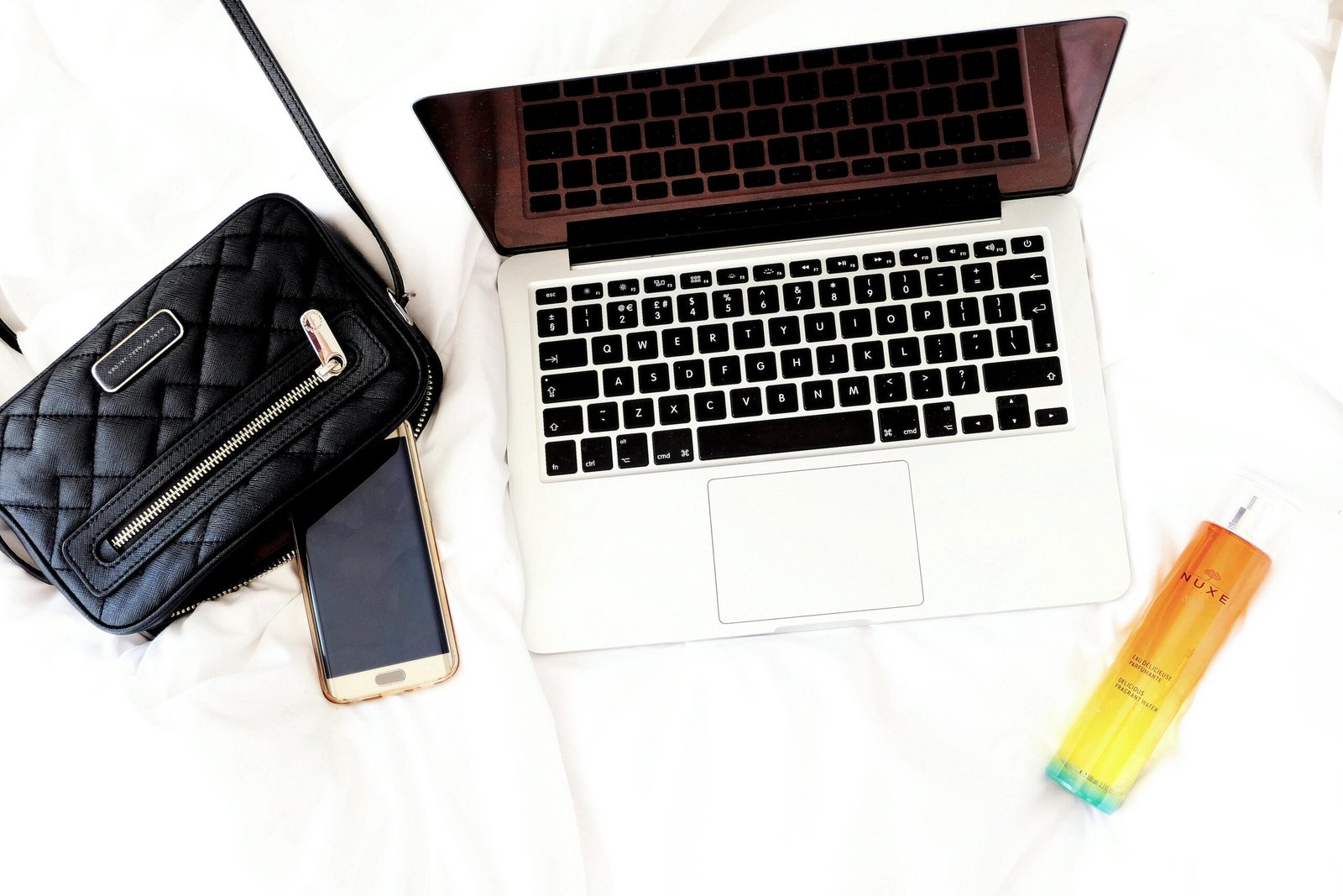 Stylish traveler placing a compact, luxurious Valentino travel perfume bottle into a chic carry-on bag, ready for a sophisticated and TSA-friendly getaway.