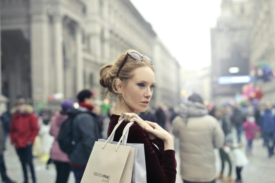 A confident traveler wearing a stylish anti-theft sling bag in a bustling urban environment, emphasizing secure travel and protection for valuables like passports and phones.