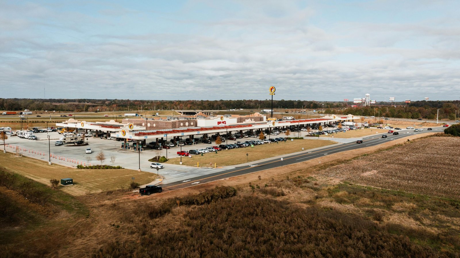 Buc-ee's Georgia travel center opening 2025: Massive highway gas station with clean restrooms, numerous fuel pumps, and famous snacks like Beaver Nuggets and Texas BBQ for road trip travelers.