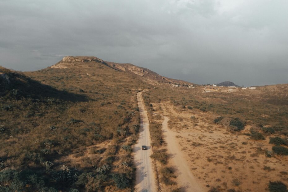 Sky City Travel Center New Mexico on I-40 at Exit 102, a modern road trip stop offering fuel, food, and authentic Acoma Pueblo crafts, set in the scenic New Mexico desert with mesas in the background.