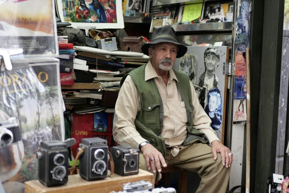 A bewildered man in 1950s clothes with a vintage camera stands in a modern cityscape, representing the Sergei Ponomarenko time travel legend and its captivating mystery.