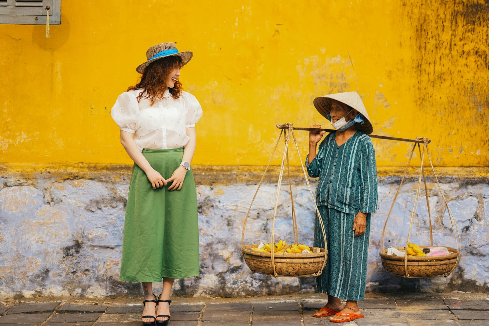 A diverse traveler and a local person sharing a warm smile during an authentic cultural exchange, illustrating the power of travel to foster understanding and break down barriers.