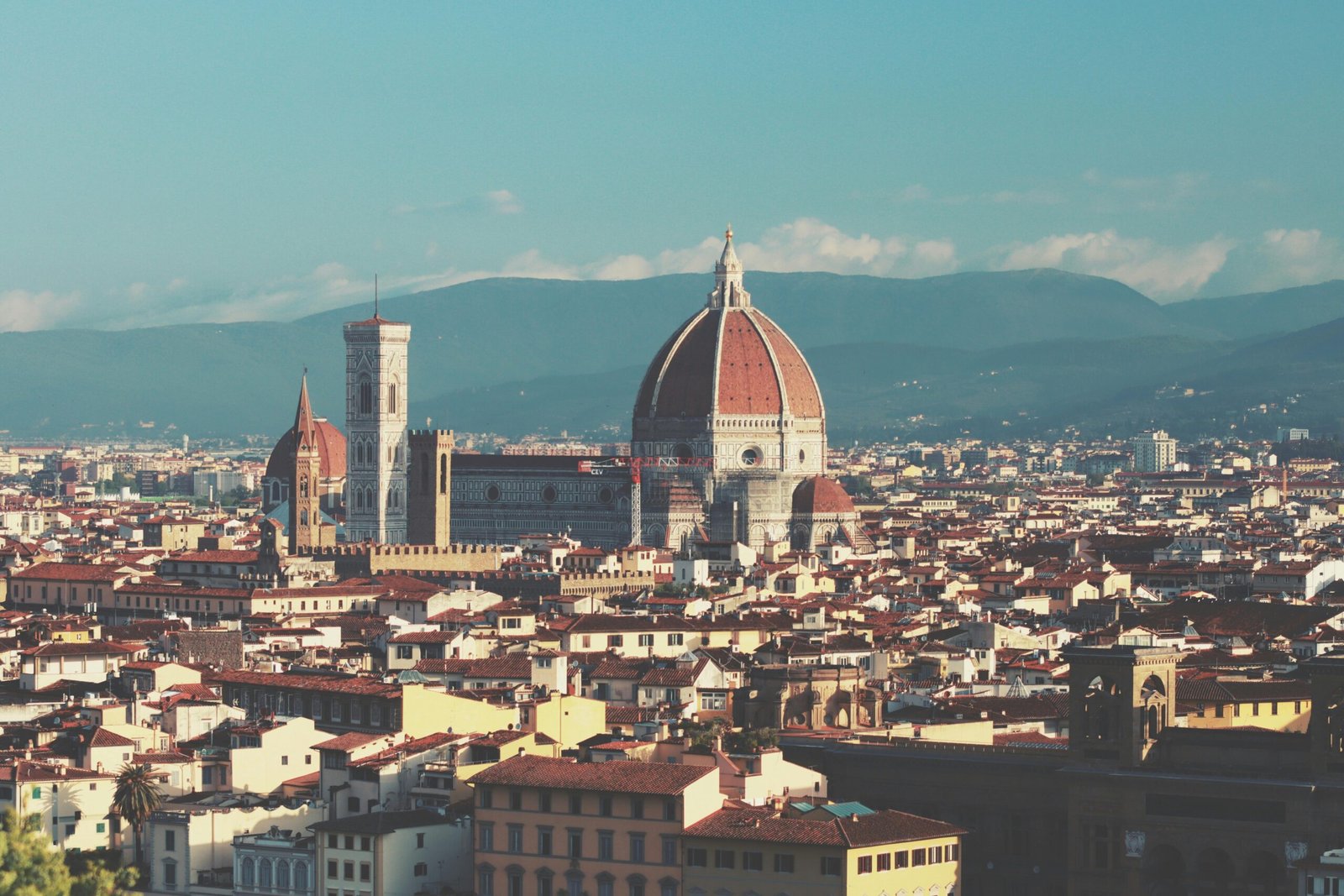 Vibrant image of a traveler enjoying the scenic beauty of Italy, showcasing a classic Italian city street or a breathtaking Tuscan landscape with historical architecture, perfect for an Italy travel guide.