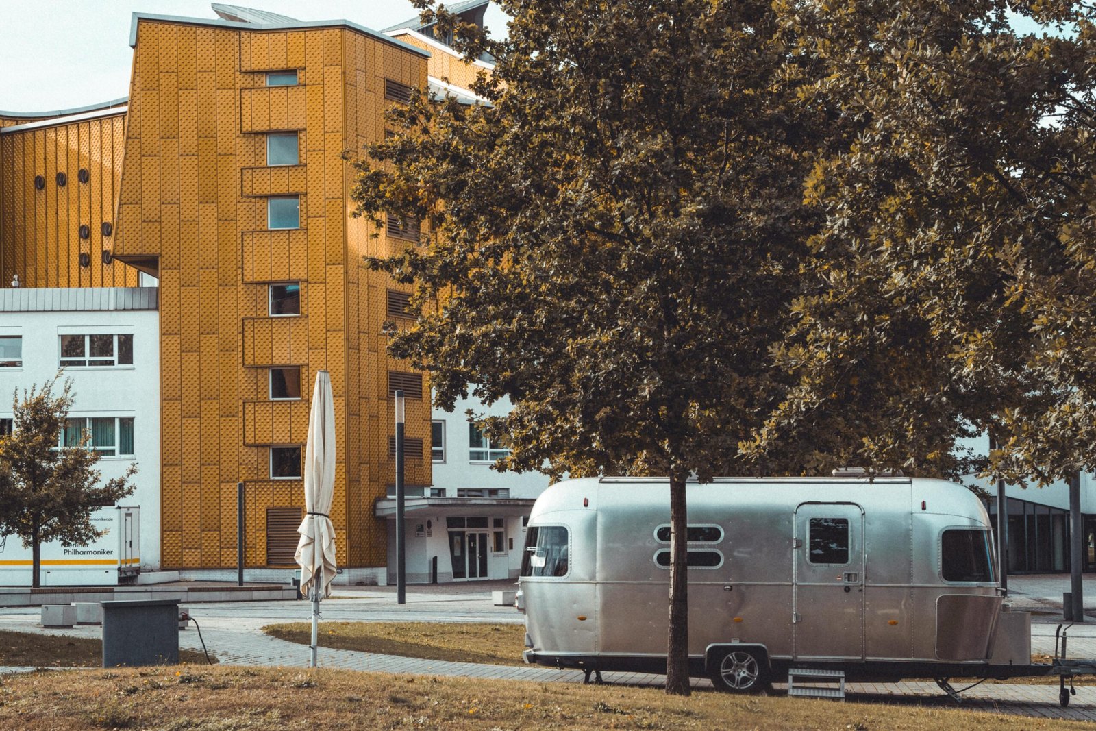 Sleek hard shell propane tank cover installed on the front of a modern travel trailer, providing essential weather and debris protection for RV propane tanks while improving overall aesthetics.