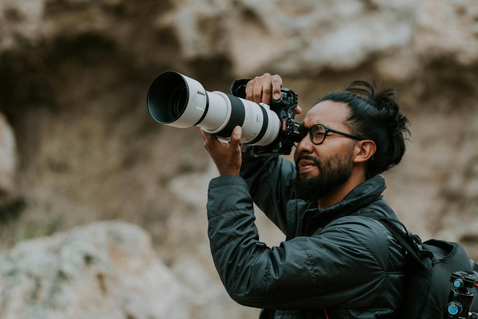 Leica SL 601 travel camera in the hands of a professional photographer, capturing a beautiful landscape, showcasing its durable build, full-frame sensor, and premium image quality for unforgettable travel memories.