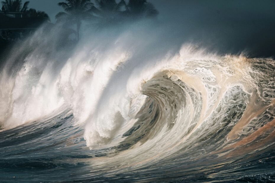 Giant tsunami wave demonstrating its long-distance ocean travel and potential for significant inland inundation, highlighting coastal community vulnerability.