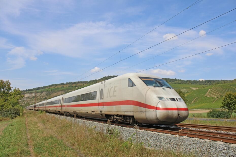 High-speed ICE train traveling through the scenic German countryside, connecting Frankfurt and Berlin efficiently and comfortably.