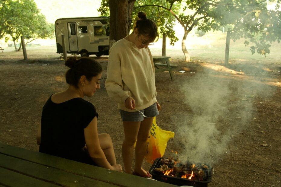 Family enjoying a modern Winnebago Minnie Winnie travel trailer campsite, highlighting comfort and outdoor adventure.