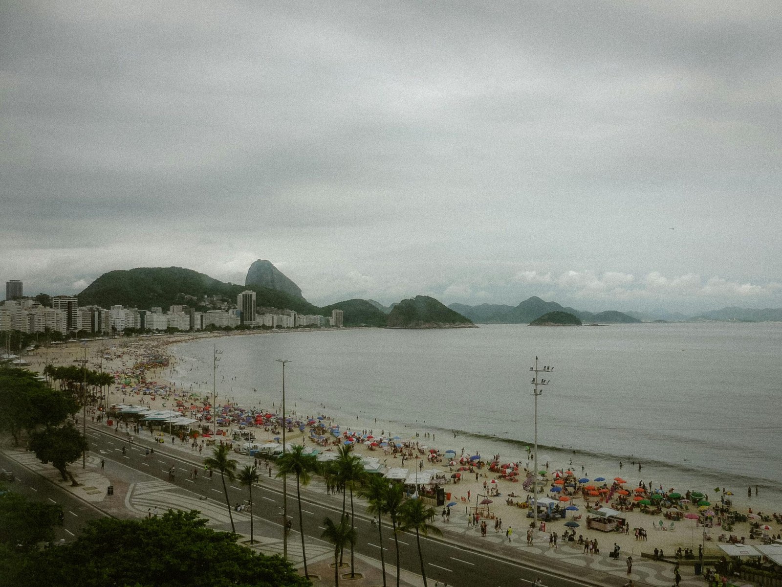 Panoramic view of Rio de Janeiro with Christ the Redeemer and Sugarloaf Mountain overlooking Copacabana Beach on a sunny day, illustrating the best time to visit during shoulder season.