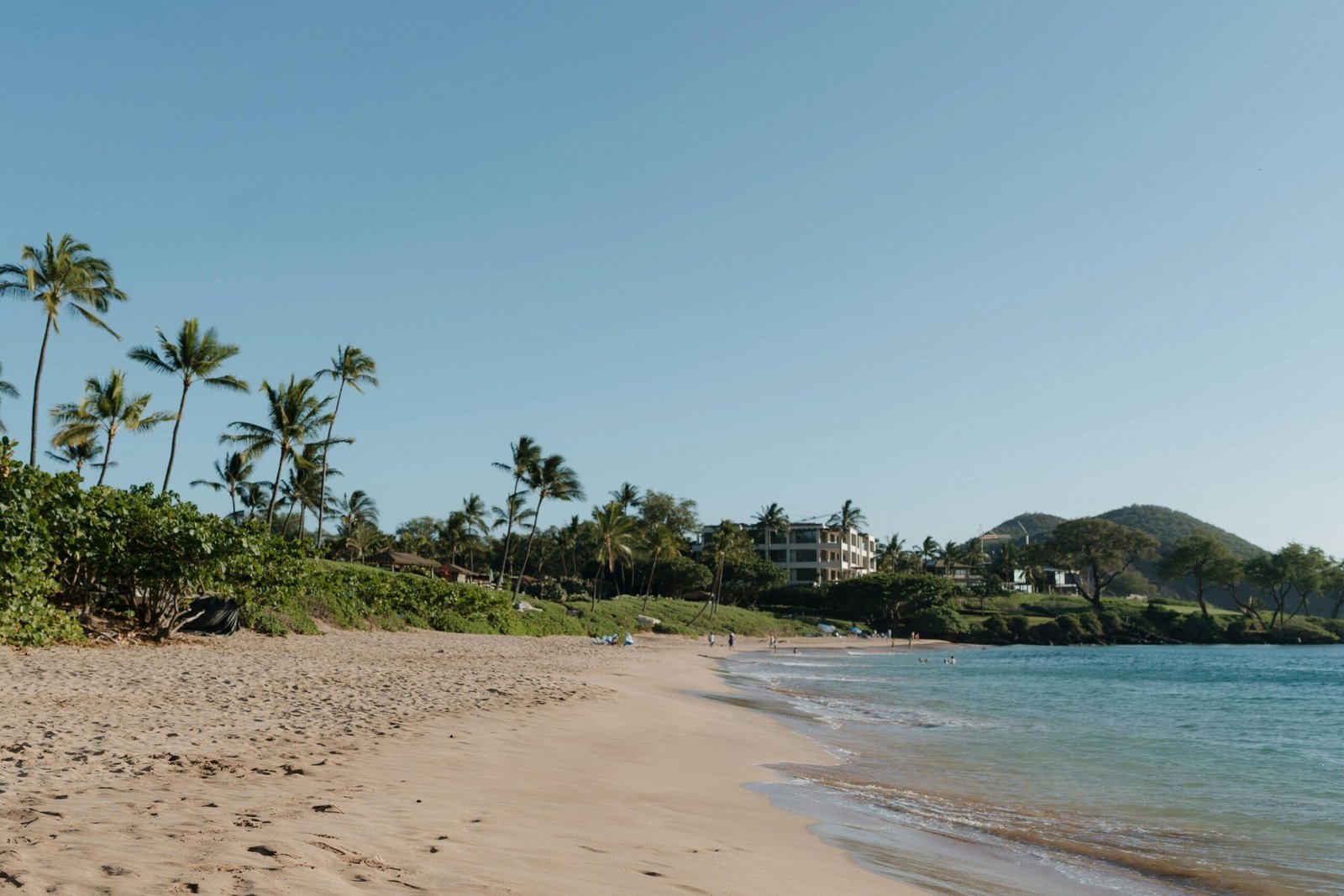 Pristine beach in the US Virgin Islands with calm turquoise water and bright sunshine, symbolizing the best time to travel for an uncrowded and perfect Caribbean vacation.