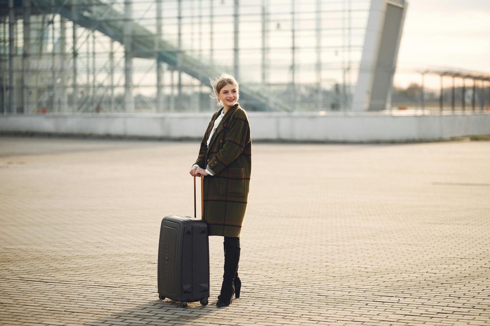 Woman confidently applying TSA-compliant travel hairspray at the airport, maintaining her perfect hairstyle for a polished look while traveling.