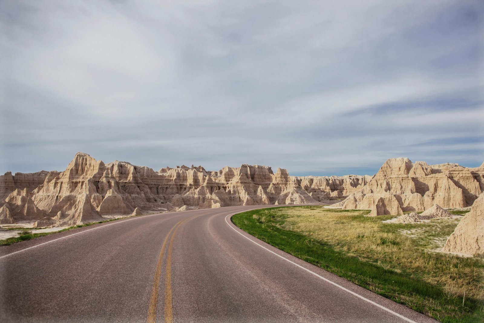 Scenic road winding through the diverse landscapes of South Dakota, highlighting the state's natural beauty, iconic landmarks, and appeal for an unforgettable American road trip adventure.