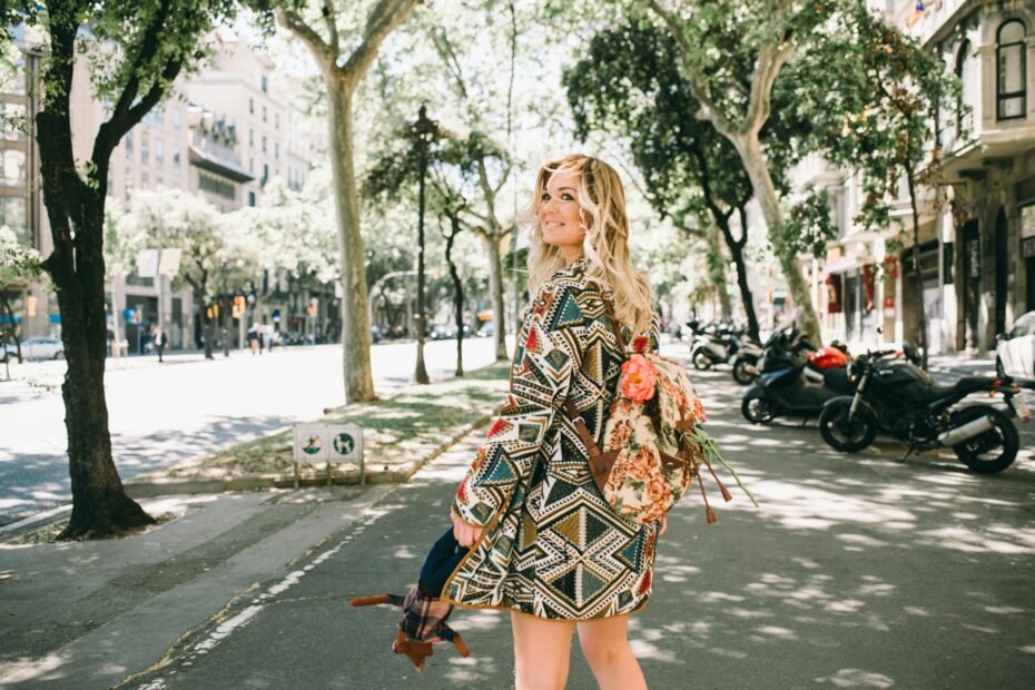 A stylish female traveler confidently walking with a comfortable and ergonomic ladies travel backpack in an urban setting, emphasizing the best travel backpacks for women.