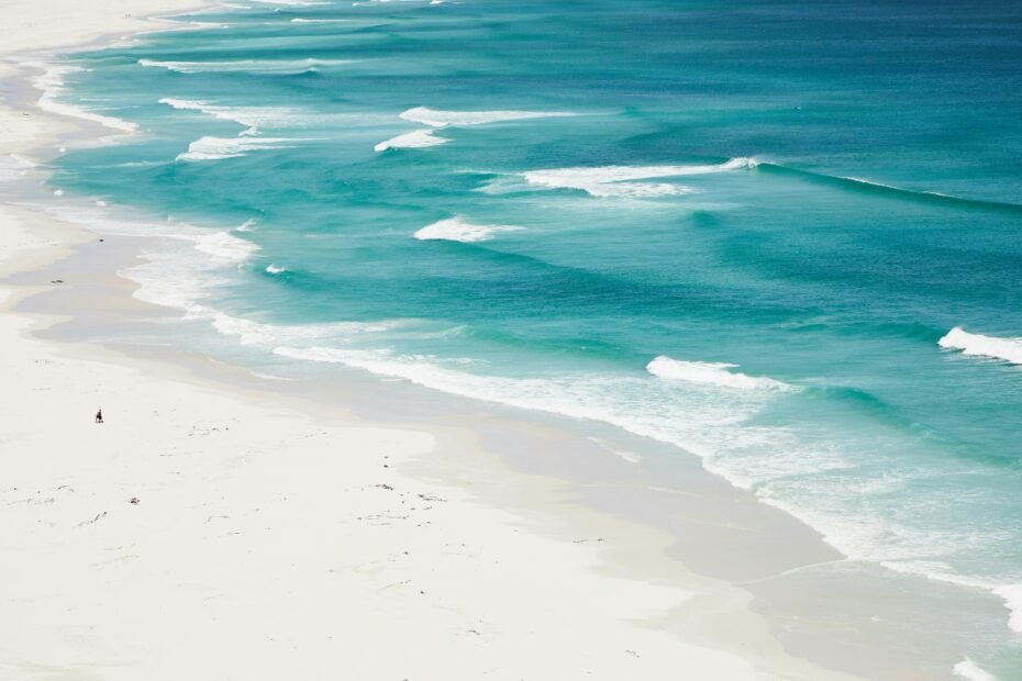 Stunning aerial view of a pristine white-sand beach and vibrant turquoise waters in St. Thomas, U.S. Virgin Islands, embodying the ideal Caribbean travel destination.