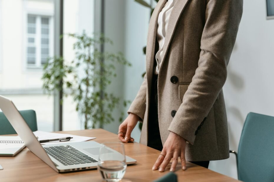 Entrepreneur planning a travel agency startup at a desk with a laptop, world map, and travel brochures, illustrating steps to establish a successful travel business.
