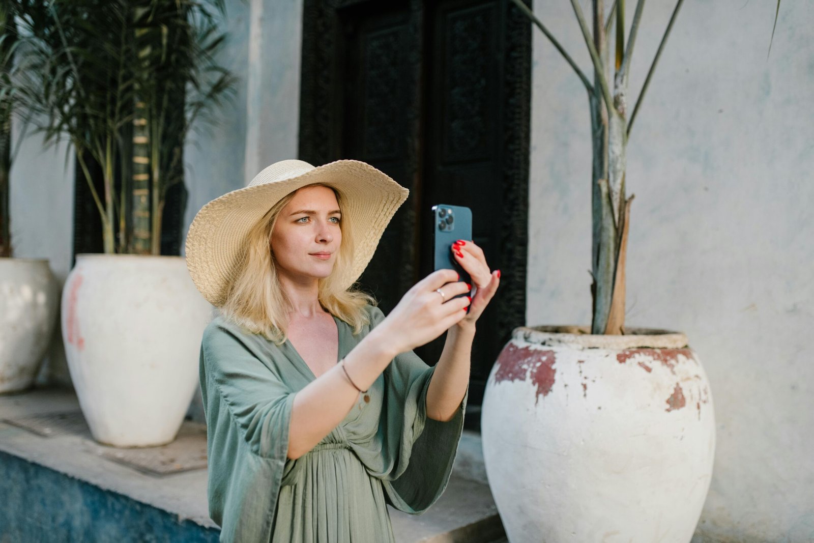 International traveler charging phone with a universal travel adapter in a Dominican Republic hotel, highlighting power compatibility for a Caribbean vacation.