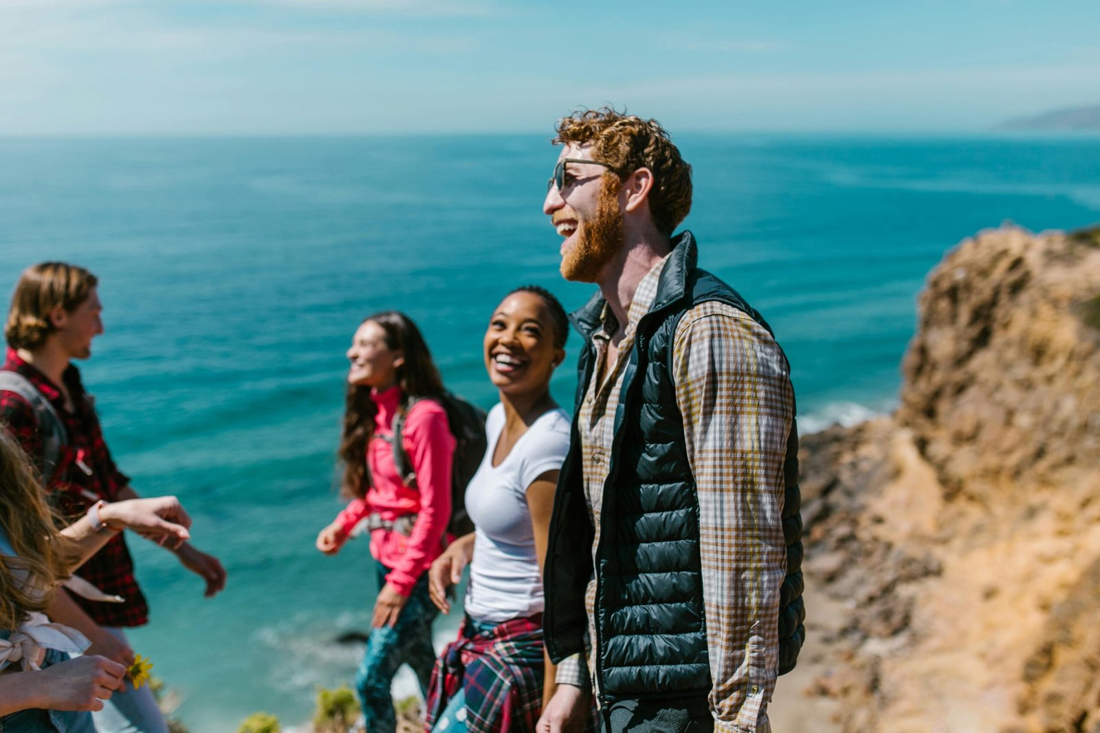 Happy diverse group of friends, family, or colleagues enjoying a stress-free travel adventure, symbolizing the peace of mind and simplified management offered by group travel insurance.