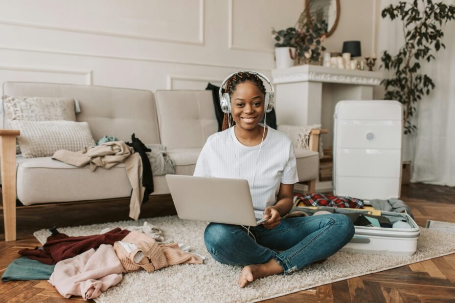 A smiling Disney travel agent and vacation planner, focused on a laptop screen while planning a magical Disney trip from a home office, surrounded by travel guides and Disney memorabilia, symbolizing expert vacation planning.