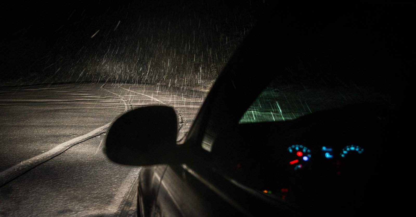 Lewis County travel advisory for safe driving in adverse weather conditions, showing a vehicle on a challenging road.