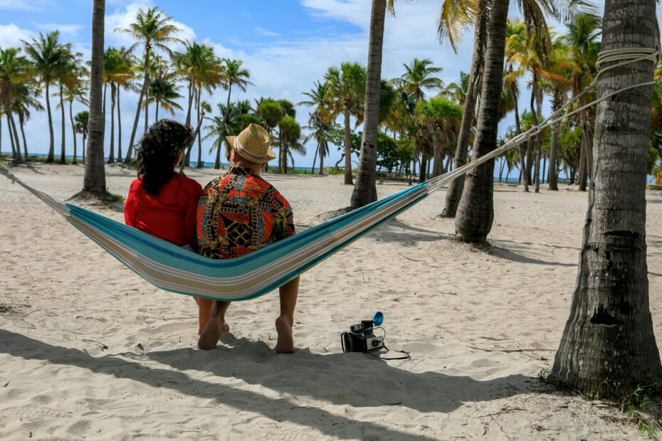 Romantic couple enjoying a beautiful tropical beach in a U.S. territory, perfect for a no-passport getaway for US citizens to places like Puerto Rico or the U.S. Virgin Islands.