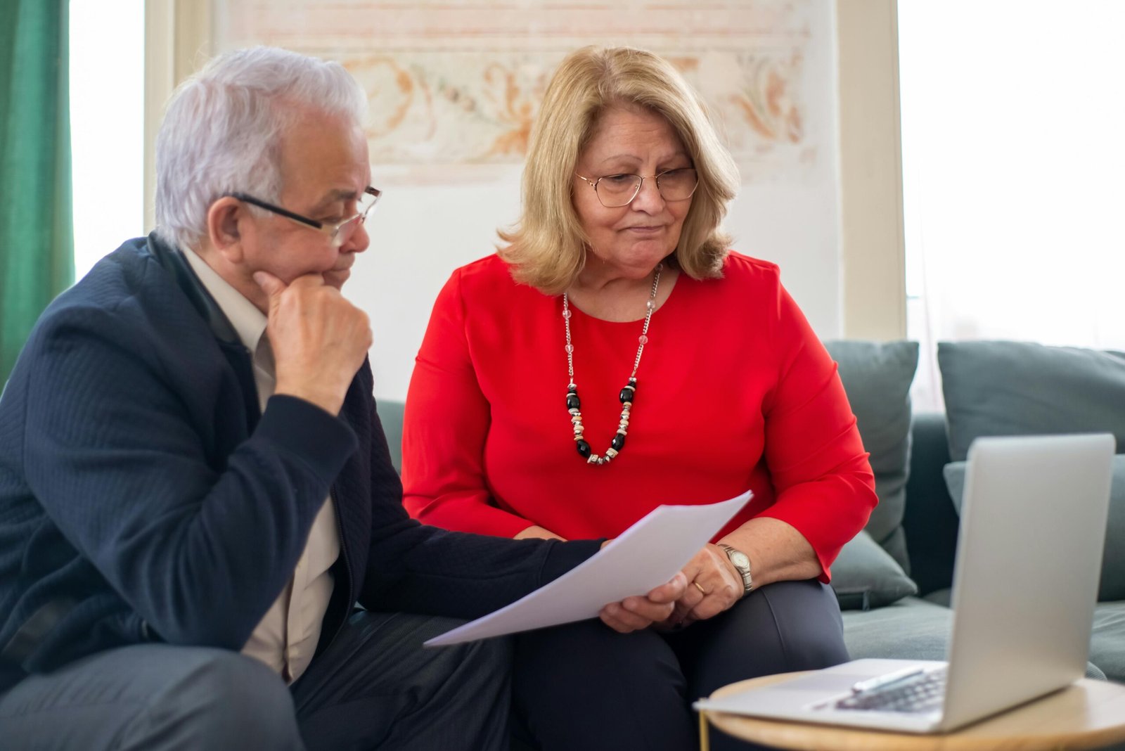 Traveler researching Berkshire Hathaway Travel Protection reviews and coverage on a laptop for confident trip planning.