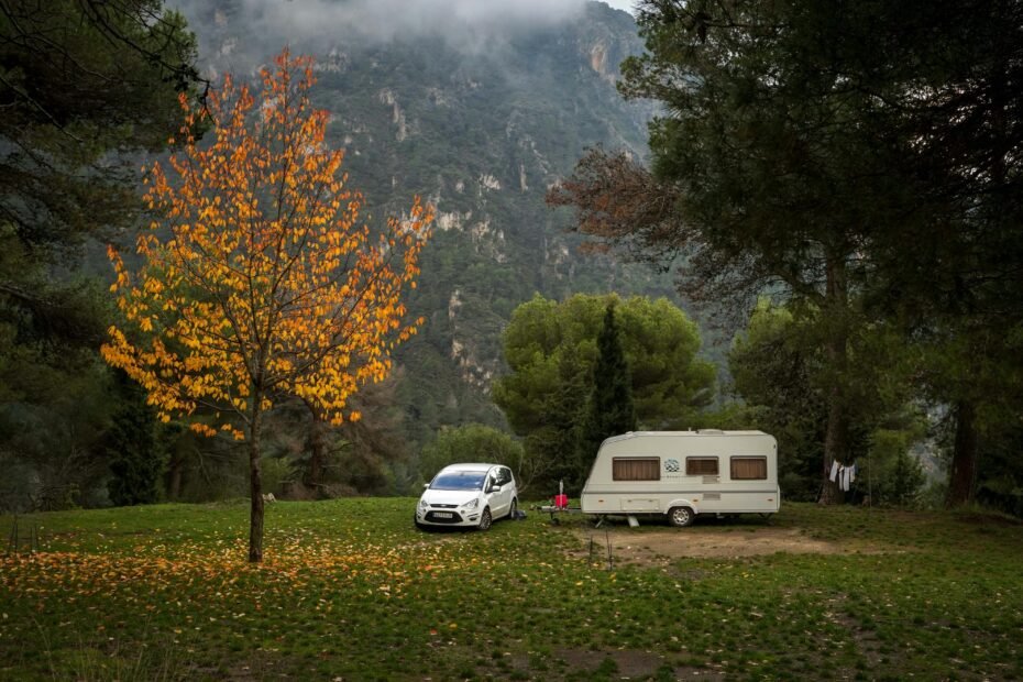 Lightweight travel trailer under 3000 lbs parked in a scenic natural campsite, illustrating easy towing and accessible outdoor adventures for couples or small families.