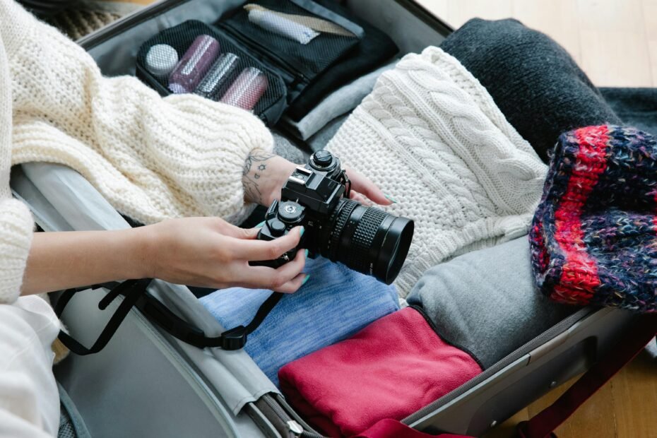 Modern leak-proof travelling soap case, possibly silicone or durable plastic, packed neatly with other travel-sized toiletries in an open suitcase, promoting hygienic and sustainable travel organization.