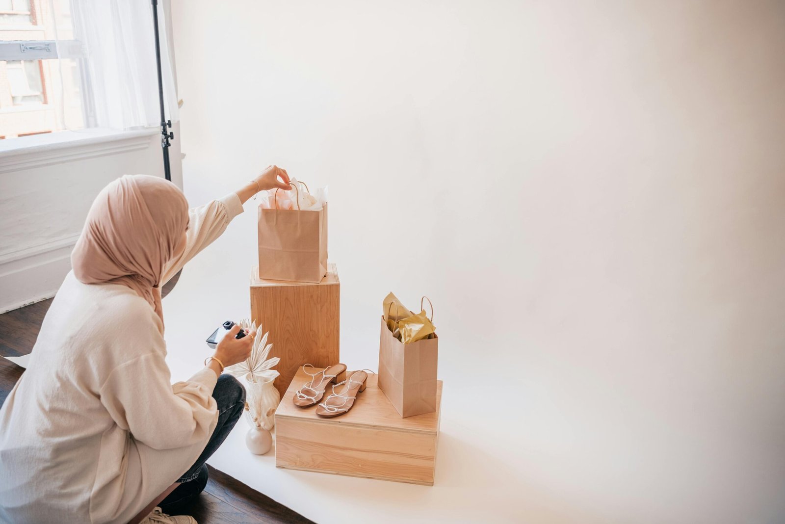 Traveling merchandiser meticulously arranging products on a vibrant display in a modern retail store, demonstrating expert visual merchandising for increased sales.