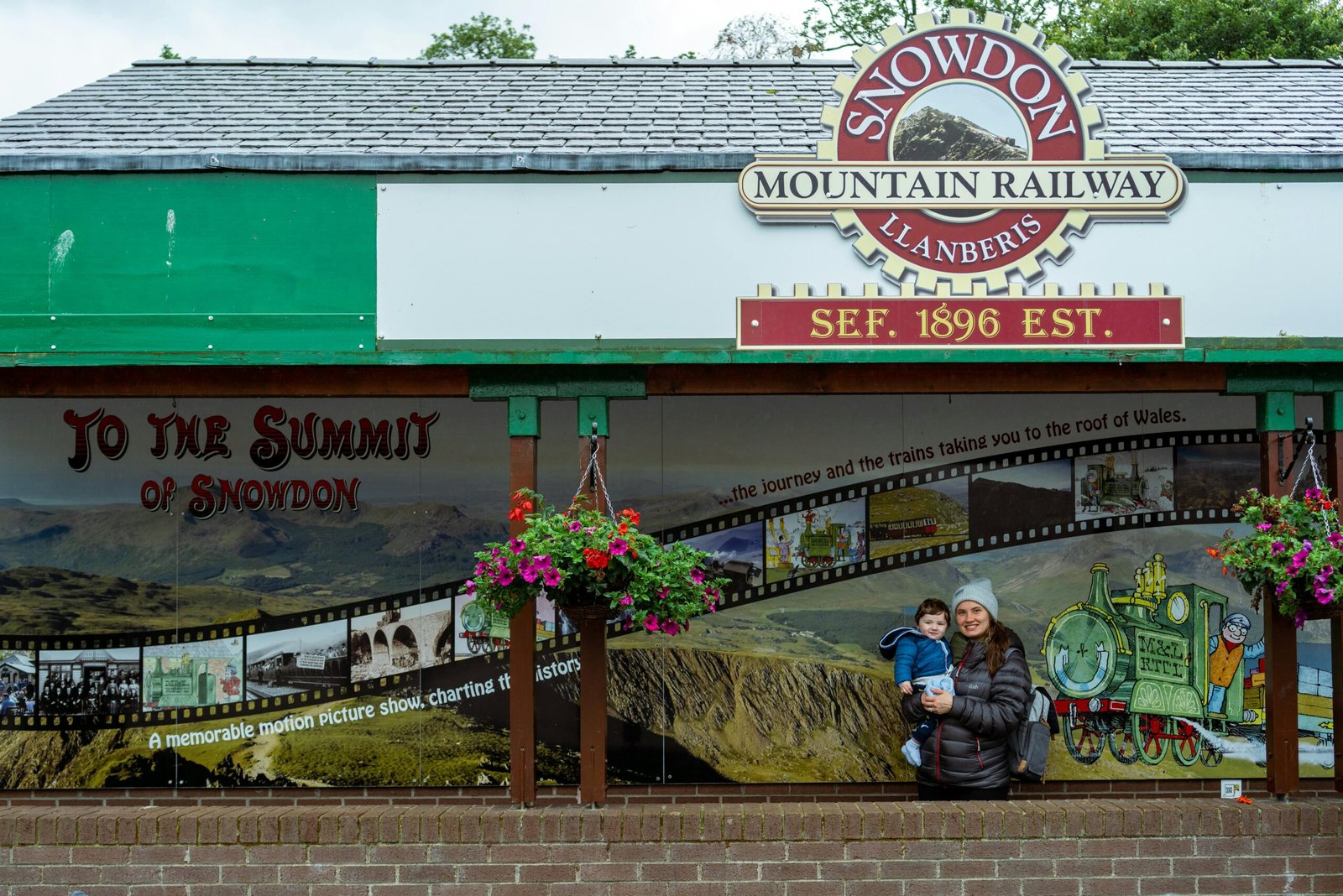 Happy parents pushing a modern baby travel system, featuring a comfortable pushchair and compatible infant car seat, designed for safety and convenience for UK families.