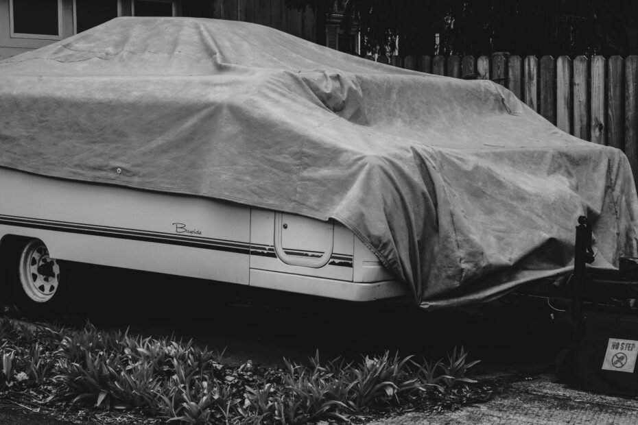 Premium RV travel trailer securely protected by a durable, multi-layer cover outdoors, ensuring its preservation and readiness for adventure.