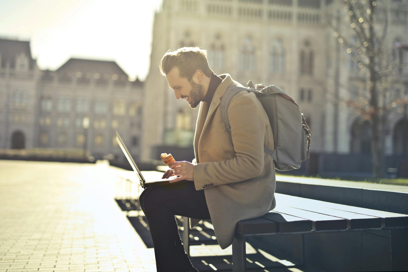 Person working on a laptop in a scenic travel destination, symbolizing the freedom and benefits of travel occupations, remote work, and digital nomad lifestyles.